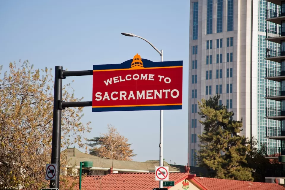 Red 'Welcome to Sacramento' sign in downtown Sacramento, California.
